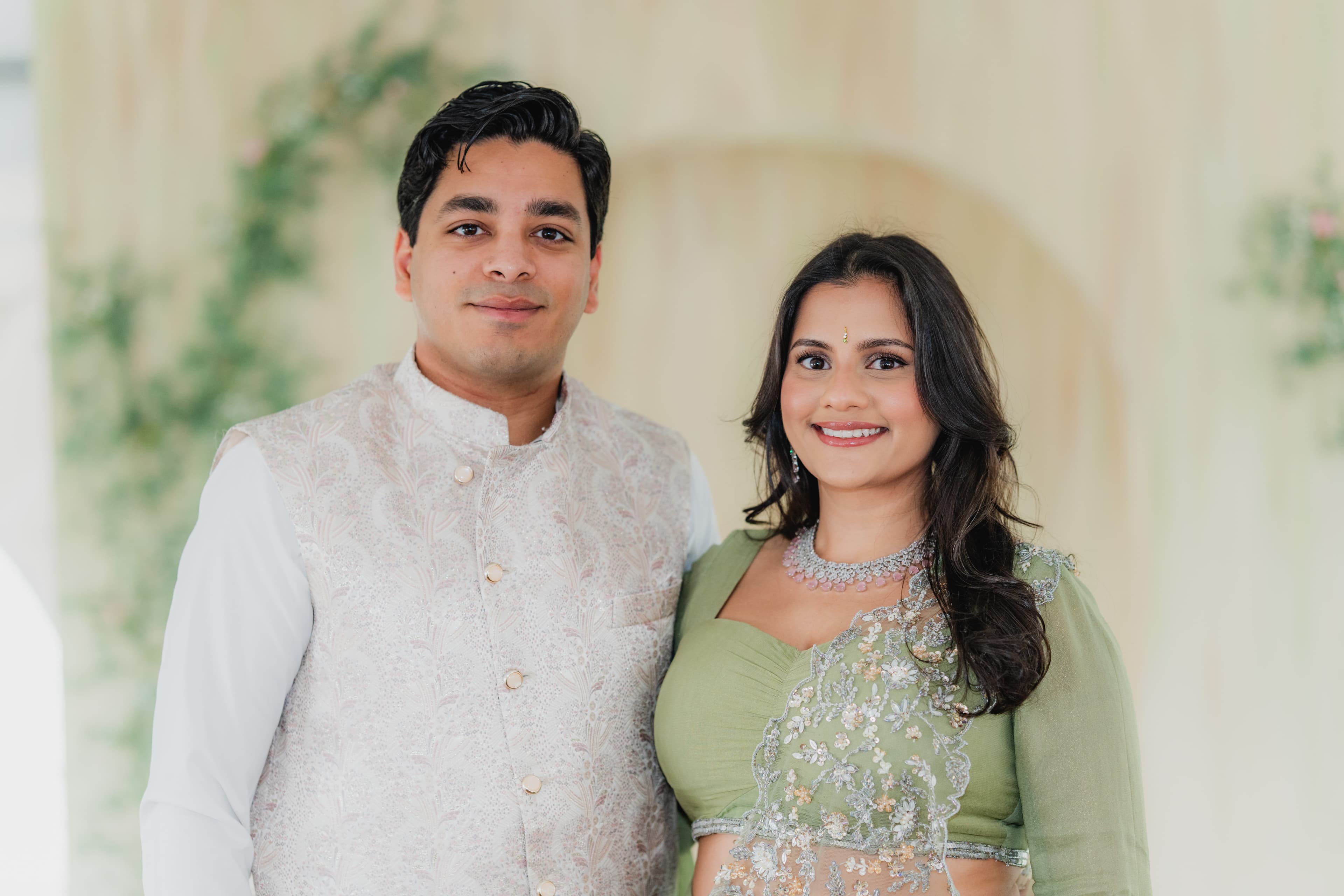 Newly engaged couple posing together at their garden celebration