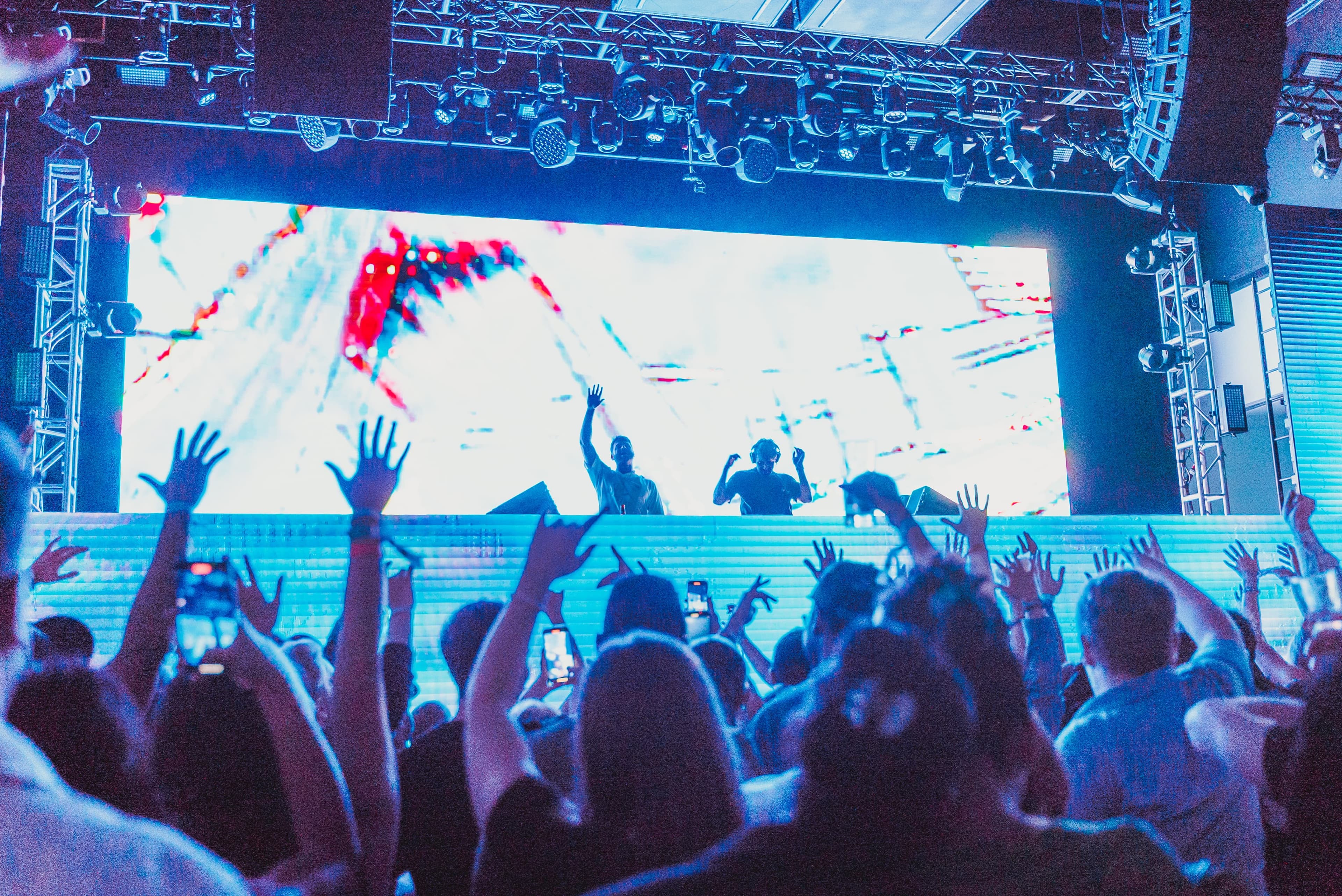 DJ performing over an energized crowd at a live corporate event